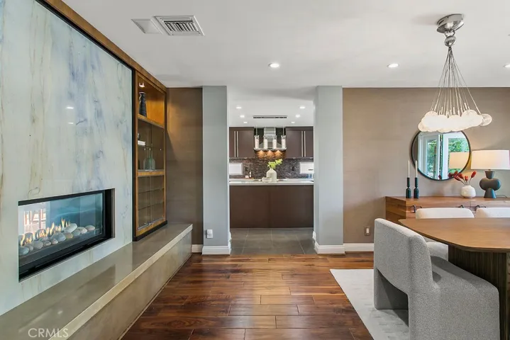 Formal dining room with fireplace and adjacent kitchen.