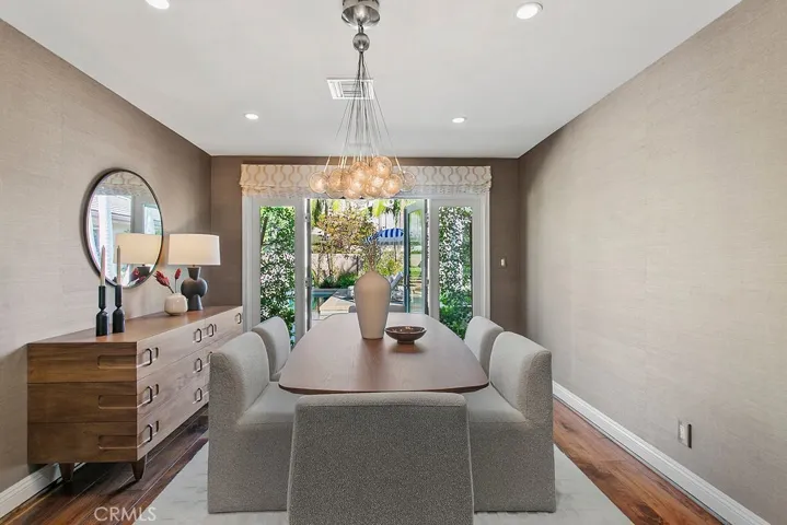 formal dining room with custom Philip Jeffries wall covering and French doors to courtyard pool/spa