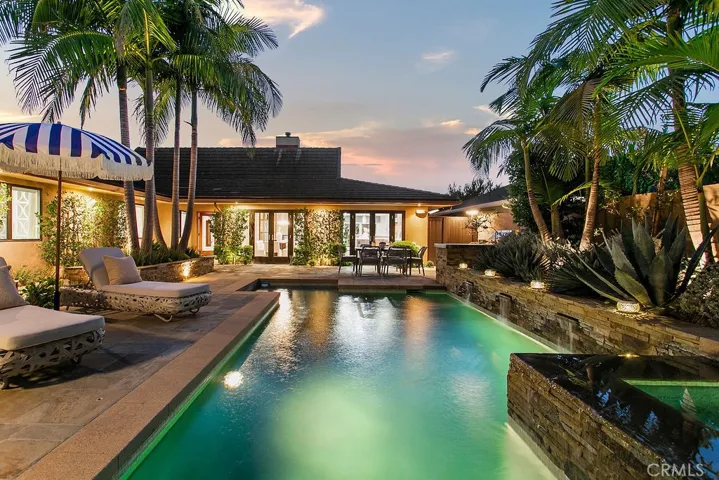 Tropical oasis behind front gates with French doors to kitchen and dining room.
