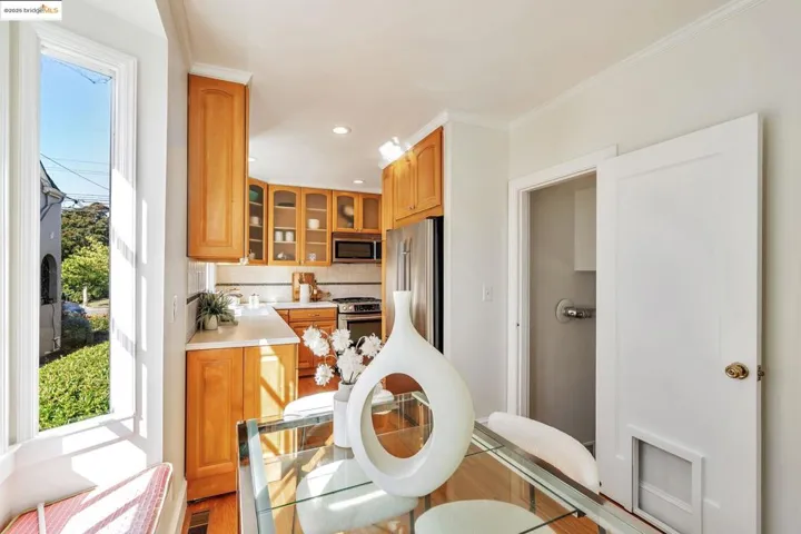 Kitchen featuring light countertops, decorative backsplash, recessed lighting, light wood finished floors, and appliances with stainless steel finishes
