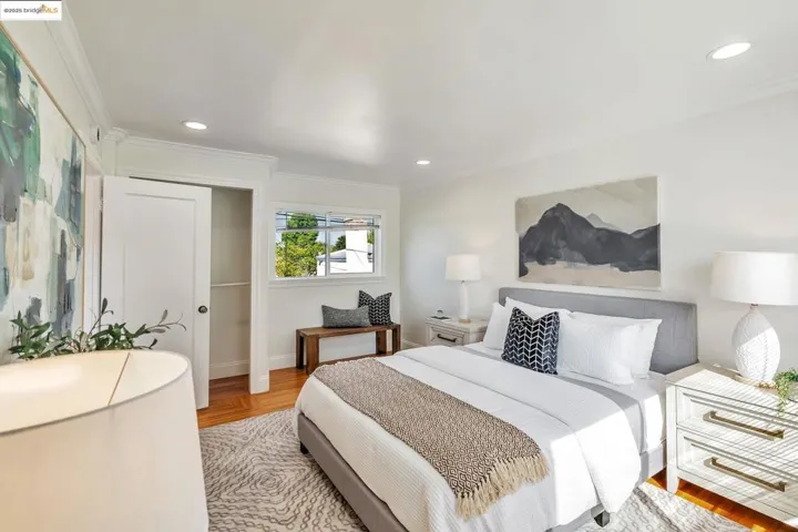 Bedroom with crown molding, wood finished floors, a closet, and recessed lighting
