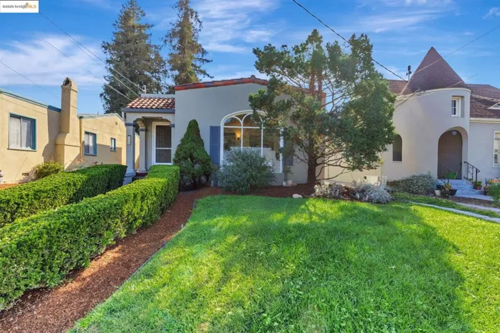 Mediterranean / spanish-style house featuring stucco siding, a front lawn, and a tile roof