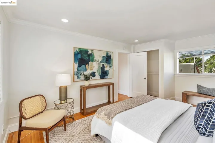 Bedroom featuring crown molding, wood finished floors, and recessed lighting