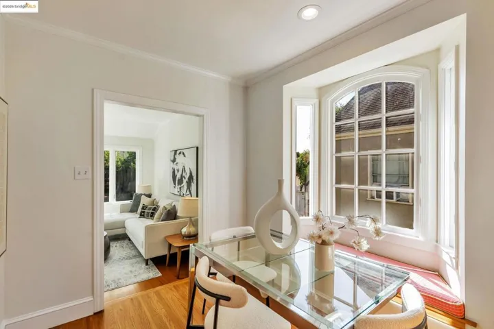 Dining room with wood finished floors and ornamental molding