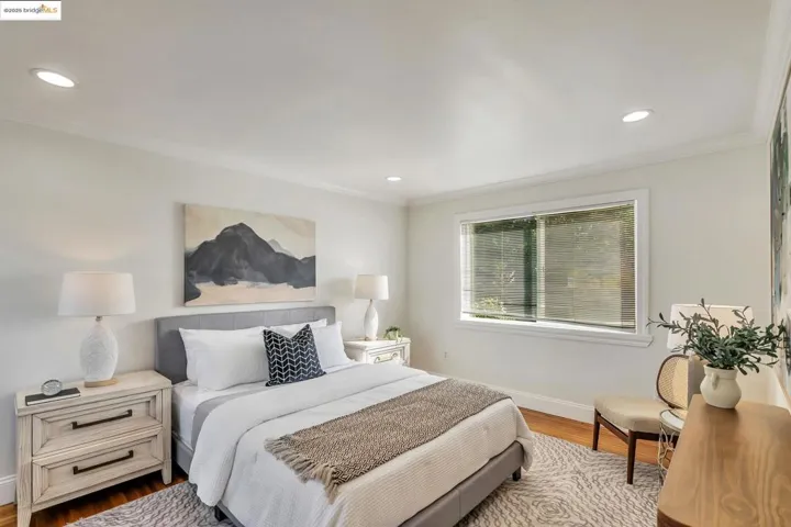 Bedroom featuring crown molding, wood finished floors, and recessed lighting