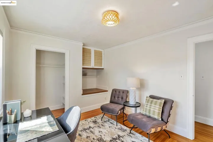 Office area featuring light wood-style floors and ornamental molding