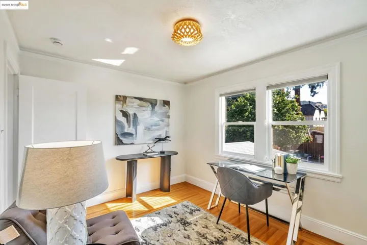 Home office with light wood finished floors and ornamental molding