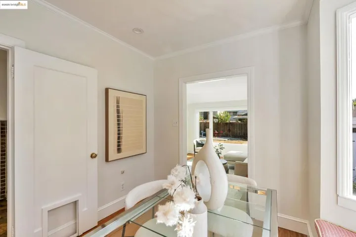 Dining room featuring ornamental molding and wood finished floors