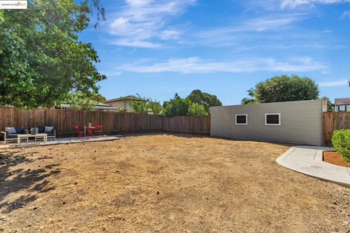 Fenced backyard with a patio area