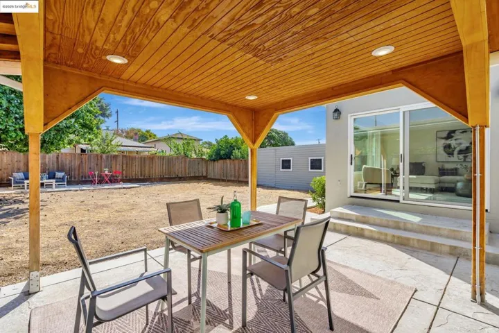 Fenced backyard with a patio and outdoor dining space