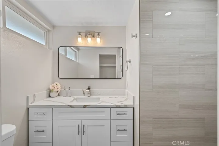 Primary bath, fully remodeled with walk-in shower and walk-in closet.