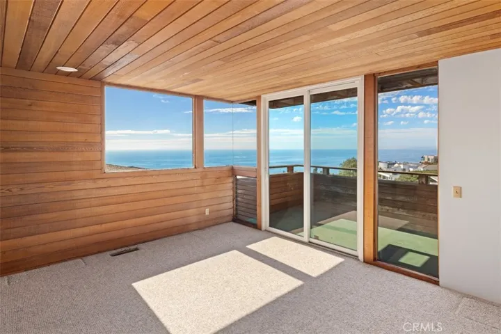 Den with balcony and ocean views