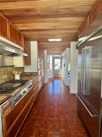 View of kitchen to Laundry and back patio
