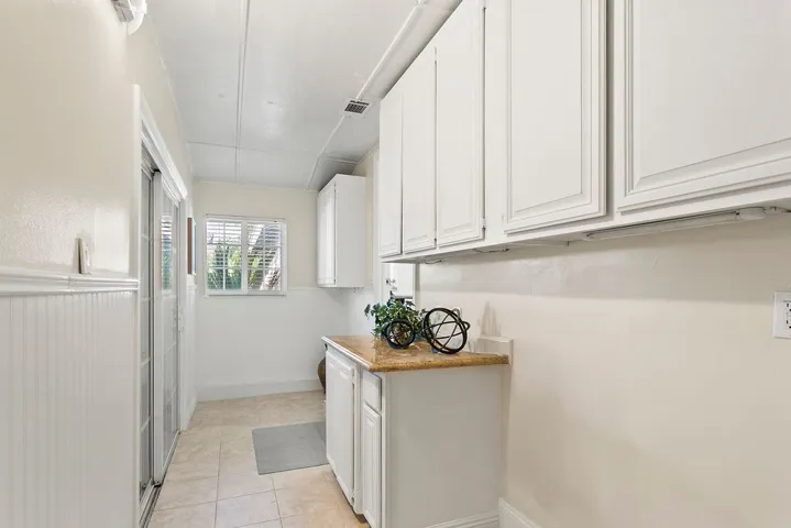 Large indoor laundry room with numerous cabinets
