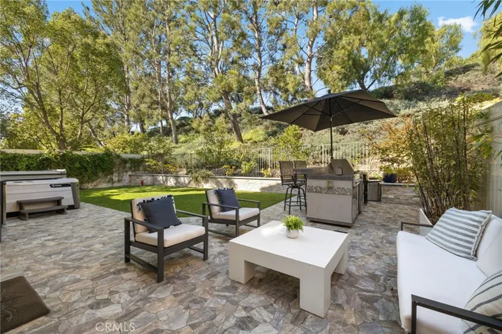Private backyard with stone hardscape and turf