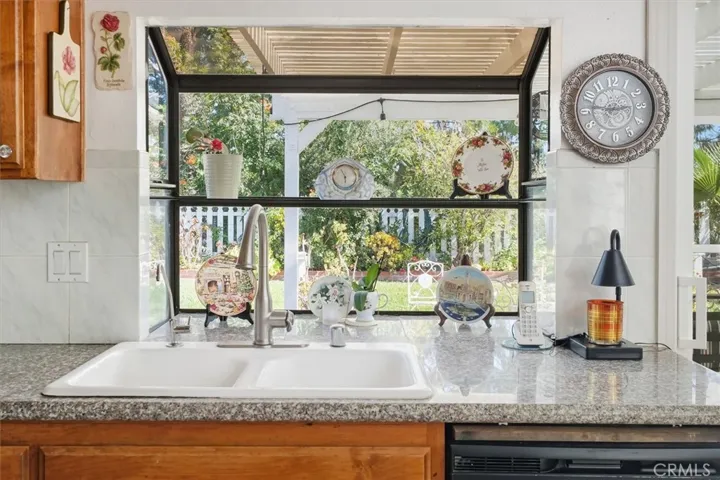 Kitchen has bay window with view of the backyard