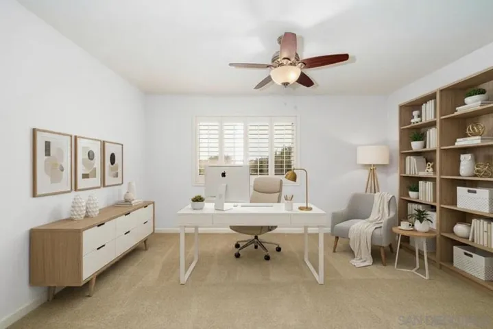 Virtually staged to show an adorable office option!