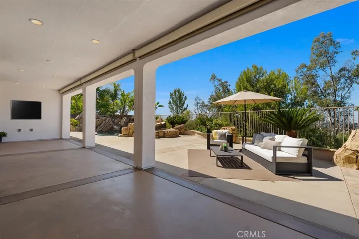 Three Large Electric Shades draw down for an intimate Patio setting.