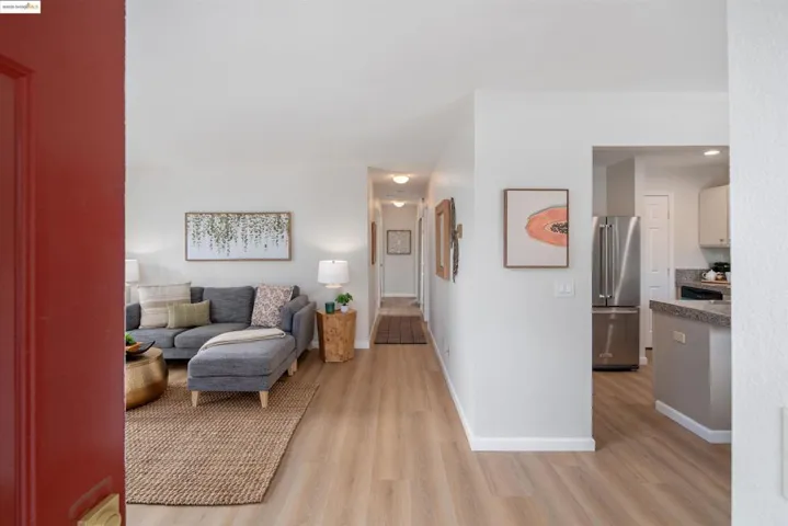 Living area with light wood-style floors and baseboards