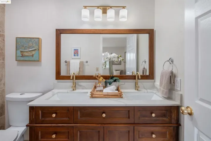 Bathroom with double vanity and toilet
