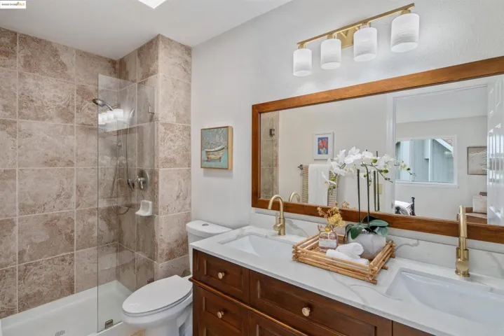 Full bath with a stall shower and double vanity
