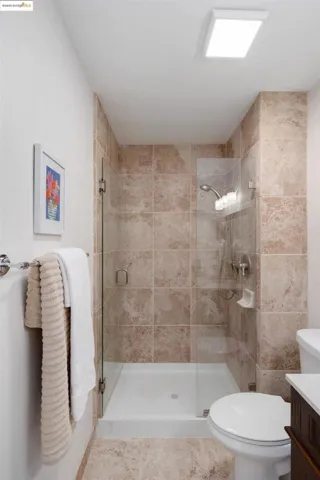 Full bathroom with vanity and a stall shower