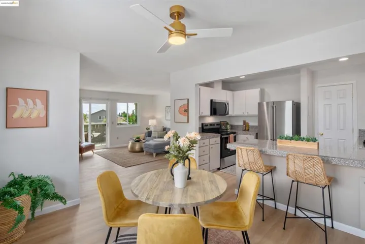 Dining area featuring light wood-type flooring, a ceiling fan, and recessed lighting