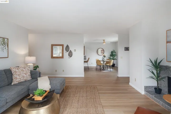 Living room featuring light wood-style flooring and a ceiling fan