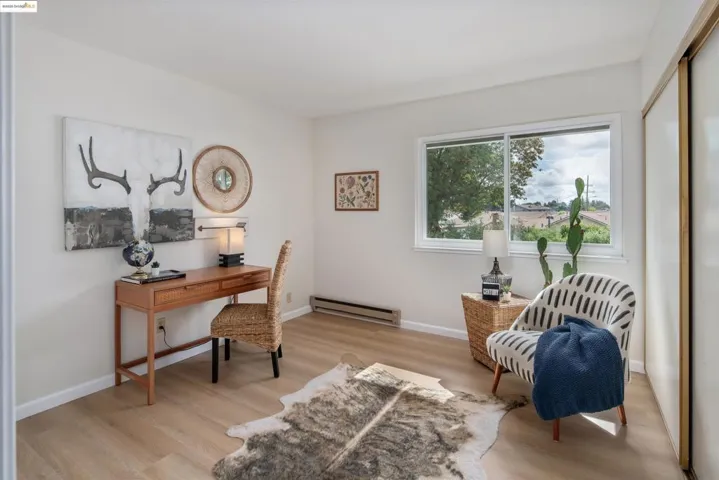 Office area featuring light wood-style flooring and a baseboard radiator