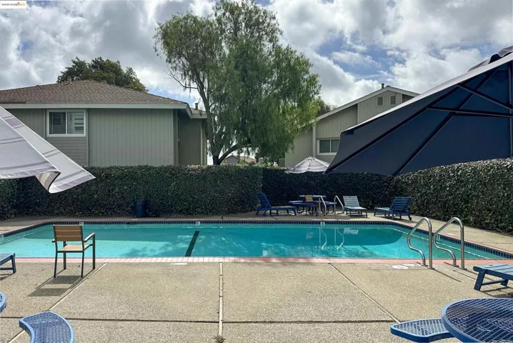 Community pool featuring a patio area