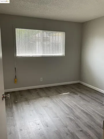 Spare room featuring a textured ceiling and light wood-style floors