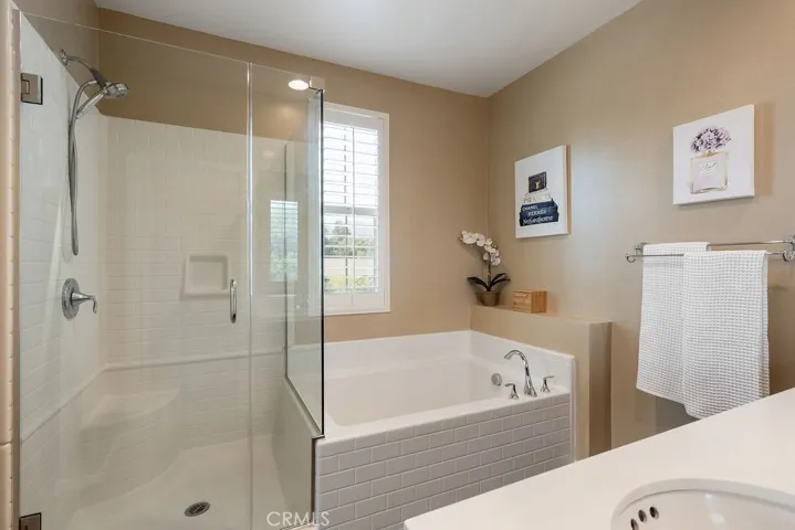 Primary bathroom offers separate soaking tub and shower
