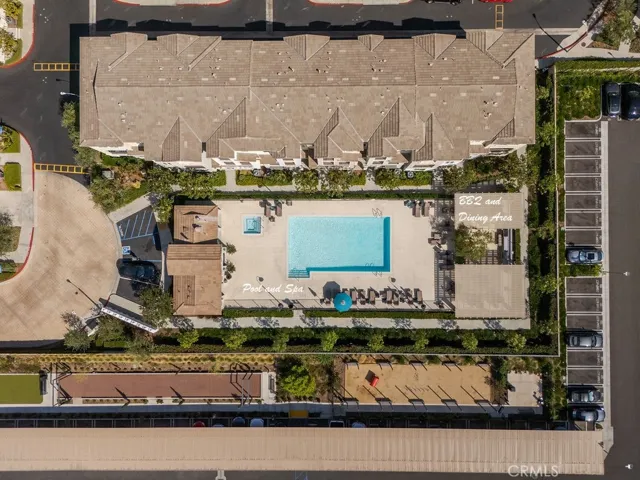 luxurious pool and spa area with outdoor kitchen, restrooms, and dining area