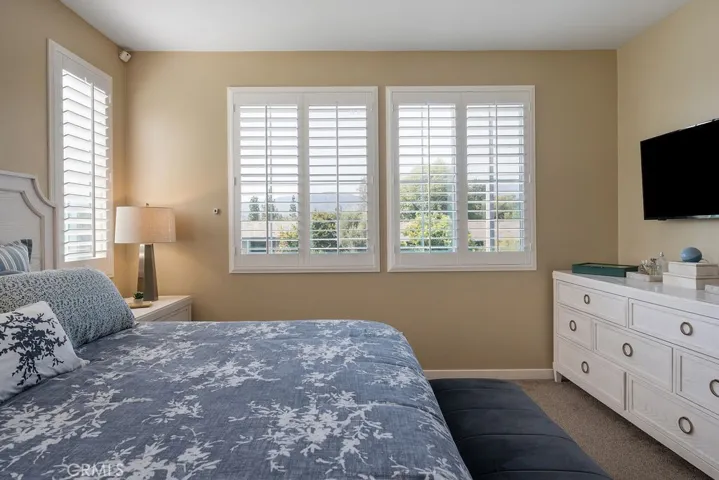 Primary bedroom offers mountain views