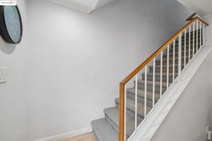 Stairs featuring baseboards and wood finished floors
