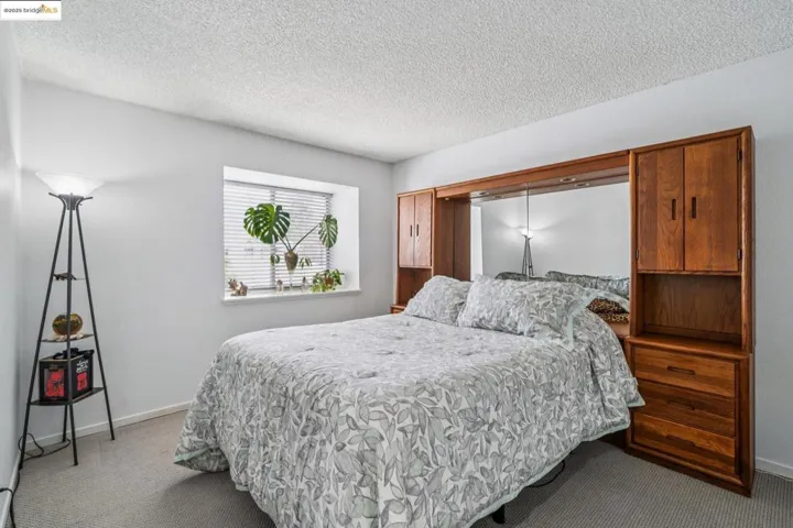 Bedroom featuring a textured ceiling and carpet flooring