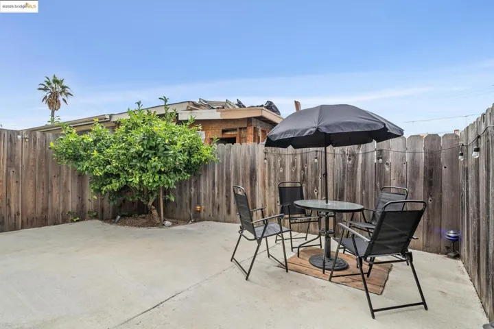 Fenced backyard with a patio area and outdoor dining area