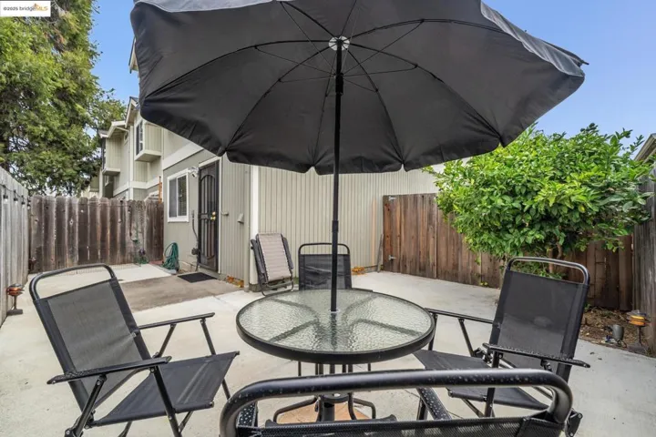 Fenced backyard with a patio area and outdoor dining space