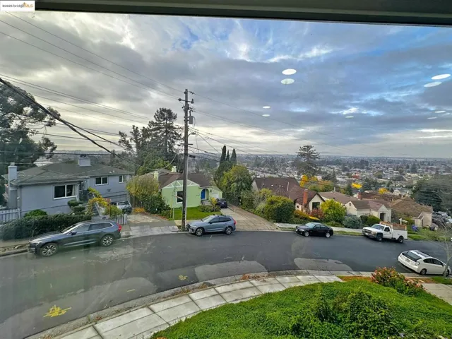 View of asphalt street with a residential view, sidewalks, and curbs