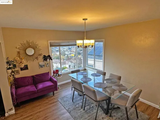 Dining area with wood finished floors and a chandelier