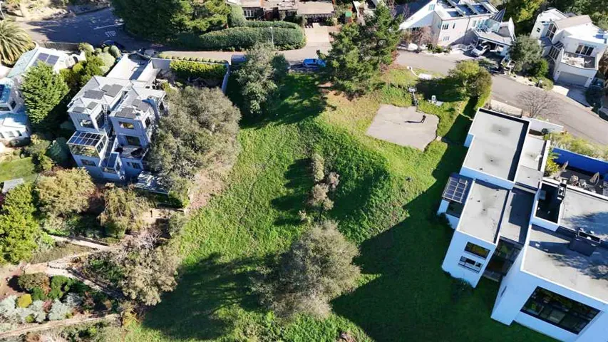 Aerial view of property and surrounding area with nearby suburban area