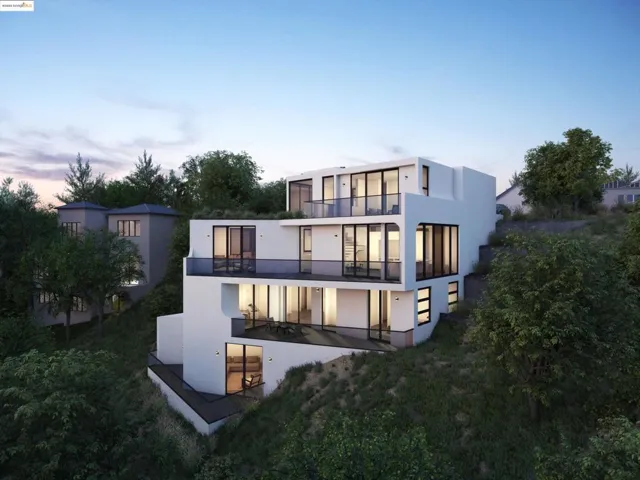Back of property at dusk featuring a balcony, stucco siding, and a patio