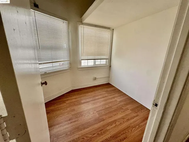 Spare room with light wood-style flooring and baseboards