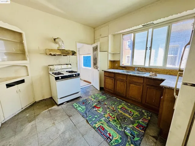 Kitchen featuring white appliances and a sink