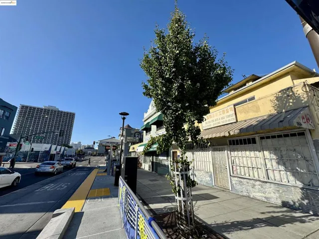 View of asphalt street with street lighting, sidewalks, and curbs