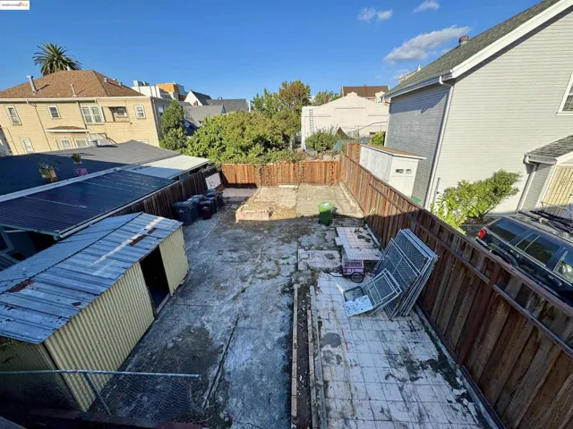 Fenced backyard featuring a residential view and a patio