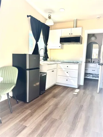 Studio bonus space left side kitchenette area w/ window view over sink area.