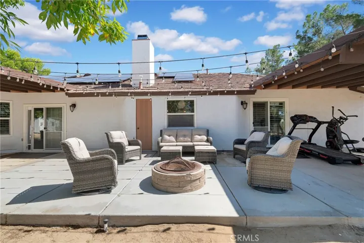 Backyard middle 
patio area open to view night stars in between covered areas.