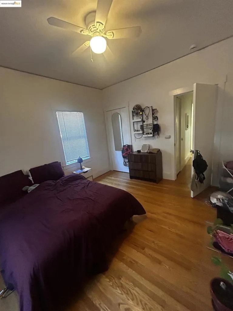 Bedroom with light wood-type flooring and ceiling fan