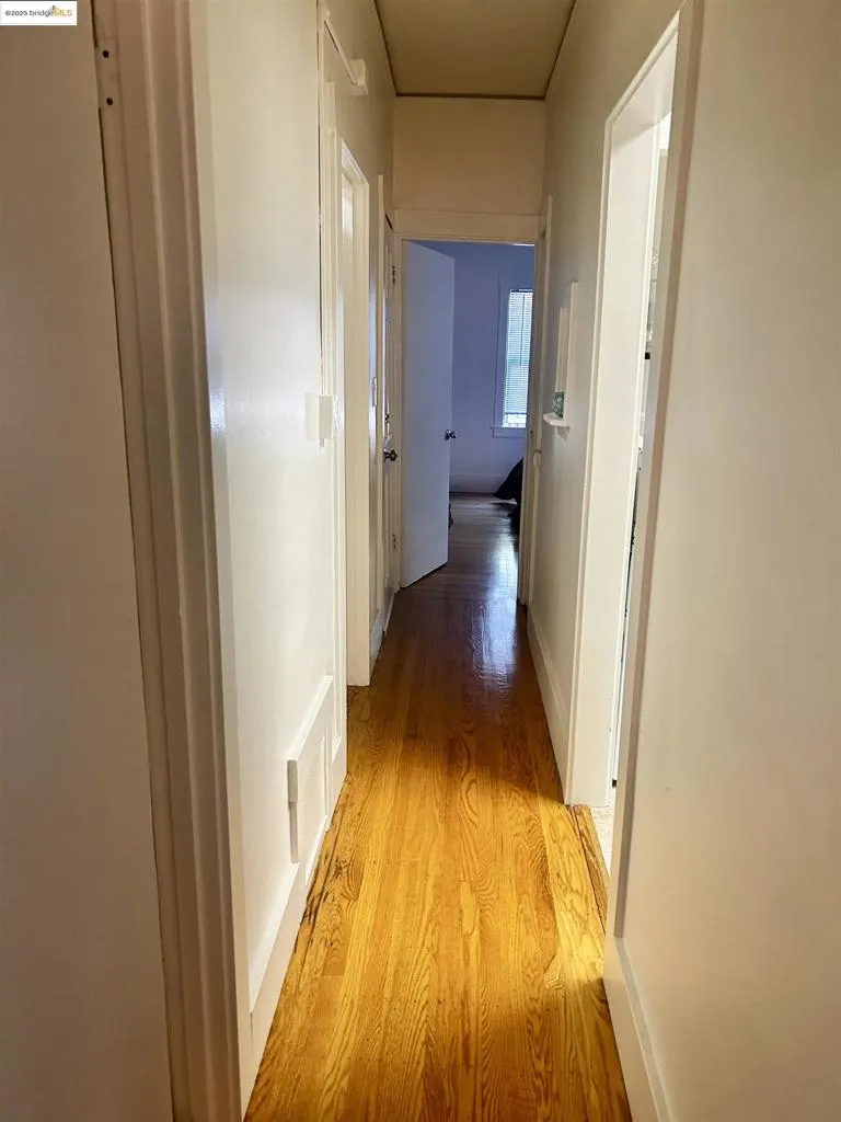 Hall featuring light wood-style floors and baseboards